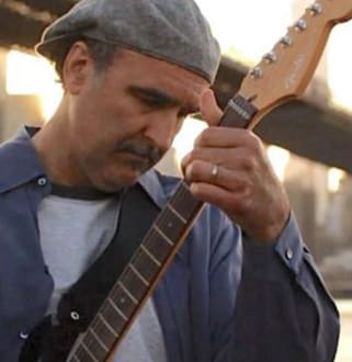 A man holding an electric guitar in his hands.