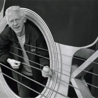 A man is standing in the doorway of an amusement ride.