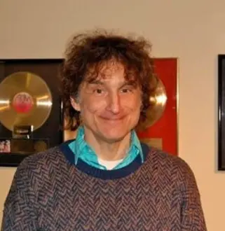 A man standing in front of some records