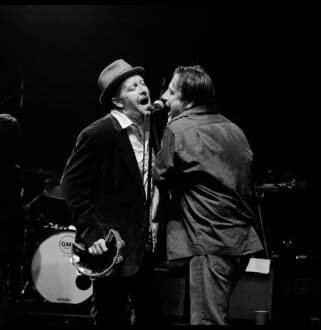 A man and a woman singing together on stage.