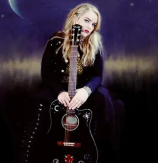 A woman holding a guitar in front of the moon.