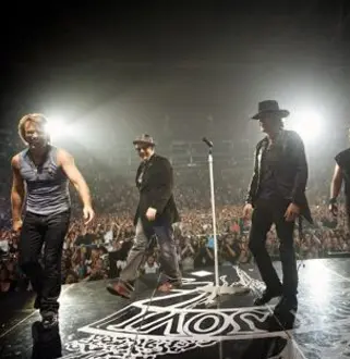 A group of men on stage performing for an audience.