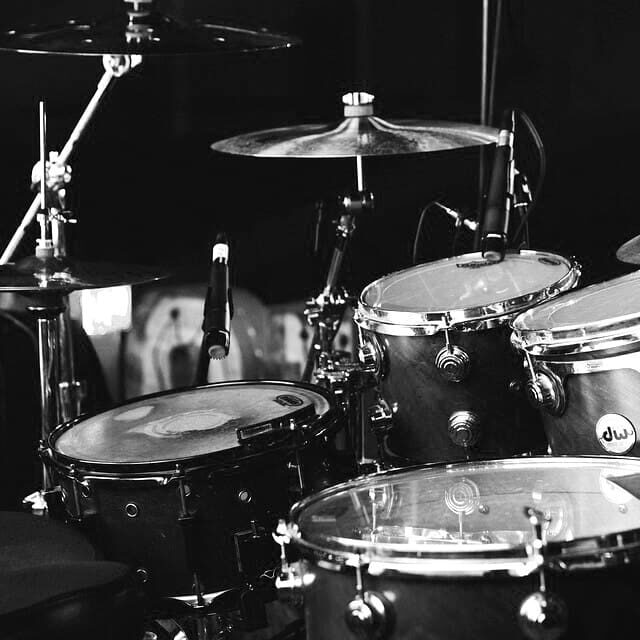 A black and white photo of drums in a band.